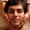 Massage Increases Oxytocin, Reduces Adrenocorticotropin massaging temples for young handsome man